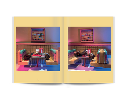 Open paperback spread with two photos of snails beside a blue table and chairs