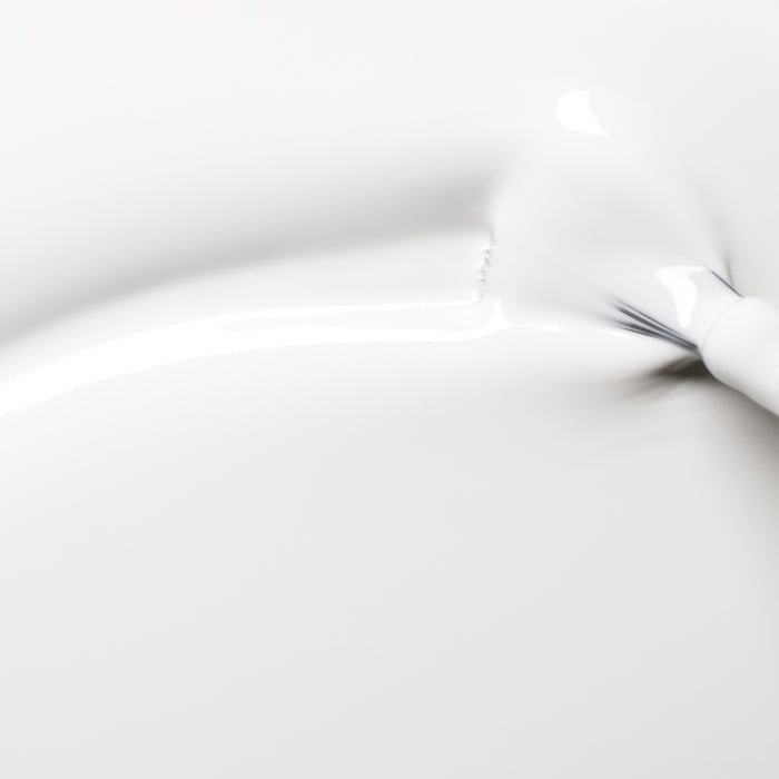 A close-up image shows Manucurist's Snow pure white nail polish smoothly spread in soft curves and gentle shadows on a clean, white background.