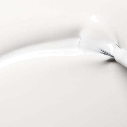 A close-up image shows Manucurist's Snow pure white nail polish smoothly spread in soft curves and gentle shadows on a clean, white background.
