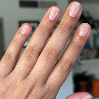 Soft Tint - Builder Gel on short natural nails with sheer blush pink and fine silver glitter manicure in soft lighting