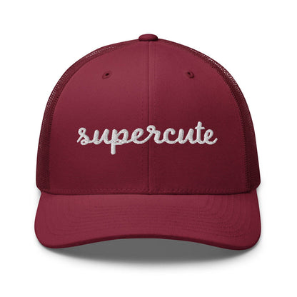 A maroon trucker-style baseball cap with 'supercute' embroidered in white script across the front, shown against a plain white background.