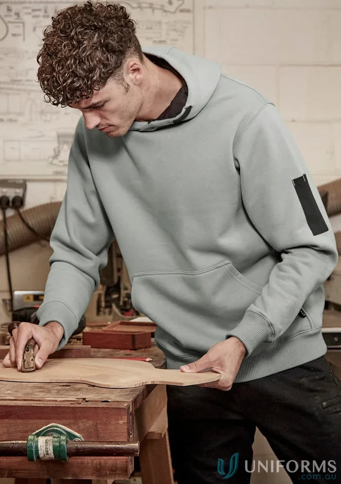 Man in a light blue Syzmic Multi-Pocket Hoodie with reinforced stress points and soft fleece lining