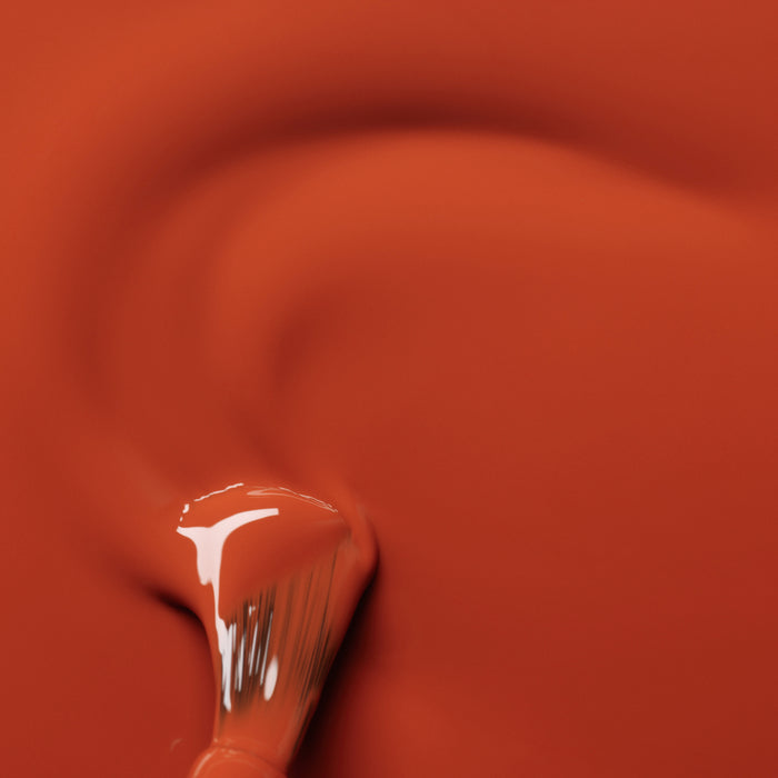 Manucurist Terracotta: a paint brush with liquid resembling scorched red earth, blending vibrant color for a striking effect.