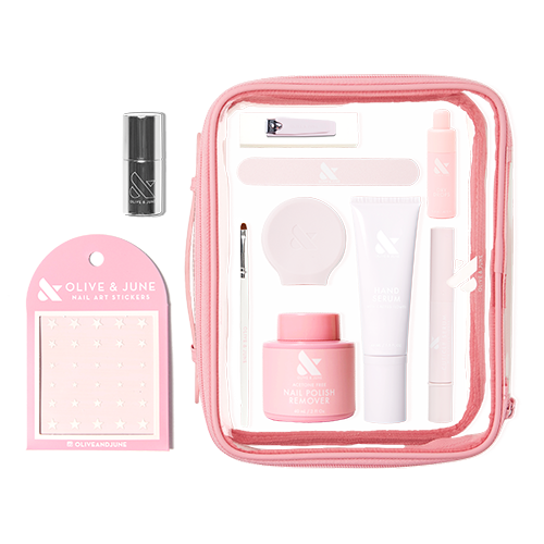 The Mani Weekender - 6 Polishes kit with nail care tools, nail polish remover, hand serum, and nail art stickers in a pink bag