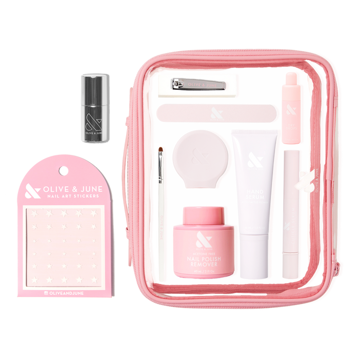 The Mani Weekender - 6 Polishes kit with nail care tools, polish remover, hand serum, and nail art stickers in a pink bag