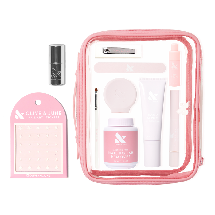 The Mani Weekender - 6 Polishes kit featuring nail care essentials, remover, hand serum, nail art stickers, and tools in a pink pouch