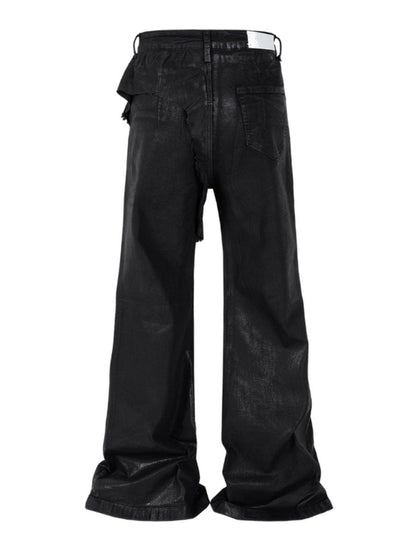 Close-up of waxed black denim fabric showing textured finish and heavyweight material