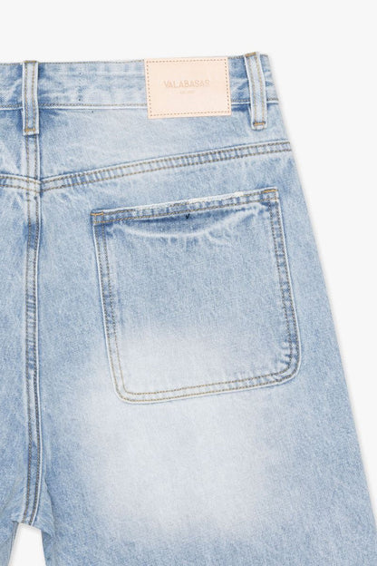 Close-up of the waistband and button closure of Valabasas Mr Shorts light blue denim shorts