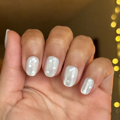 Velvet Pearly Hearts - Tab Press On | Extra Short | Round false nails with pearly velvet finish and small white heart details on hand