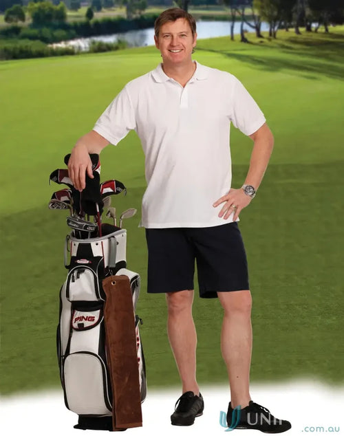 Man in spirit chino shorts standing next to golf bag, great for all-day comfort