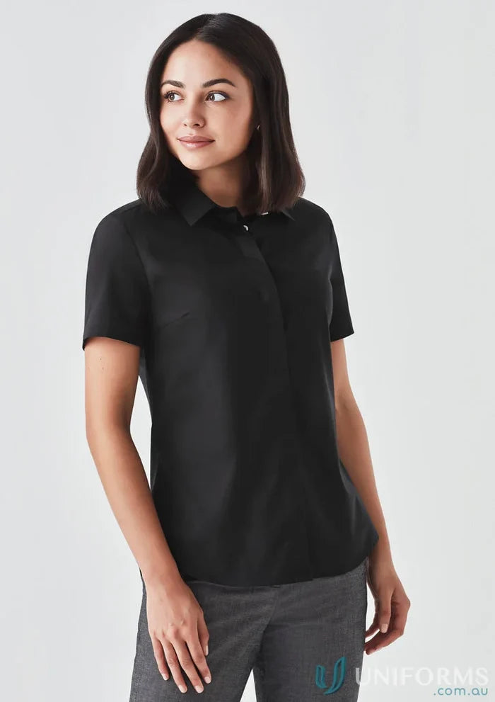 Woman wearing the Women’s Charlie SS Shirt in black showcasing a hidden bust design