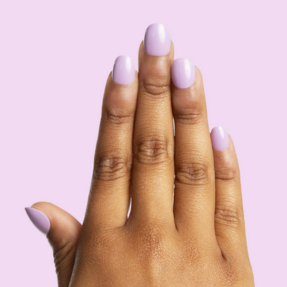 You're Invited - Pressies | Extra Short Short | Round showing hand with pastel purple press on manicure nails on light lavender background